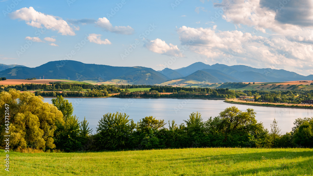 Mountain panorama from the village of Besenova, view of the high mountain peaks in the Low Tatras National Park. View from the shore of an artificial water reservoir on the river Vah.