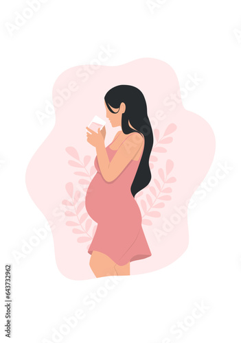 A pregnant woman drinking milk, side view
