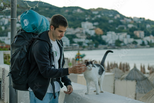 camp guy pats a cat 