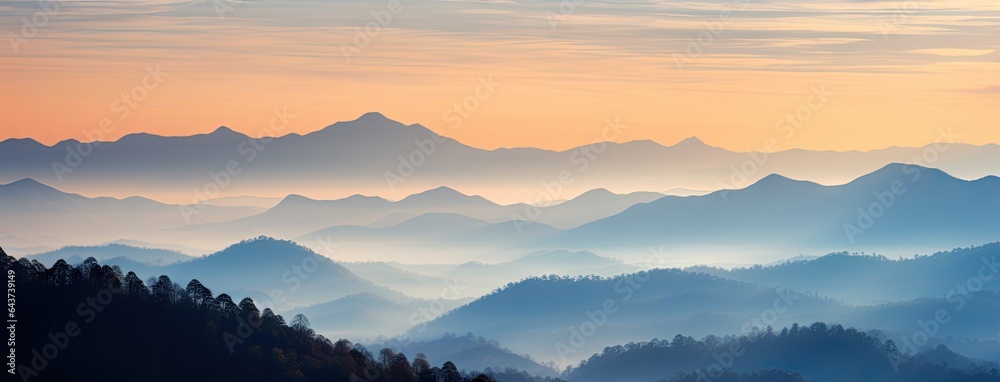 A stunning mountain range illuminated by the warm colors of a breathtaking sunset