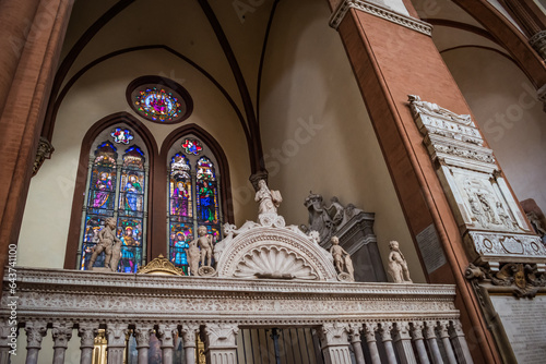 Gate decorated with statues and colorful stained glass windows with religious scenes inside the Basilica di San Petronio, Bologna ITALY photo