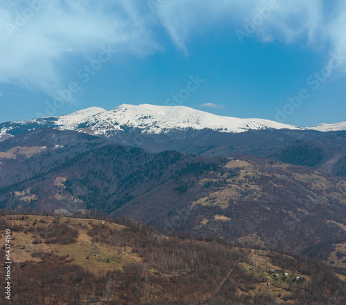 Early spring Carpathian mountains plateau landscape with snow-covered ridge tops in far, Ukraine.