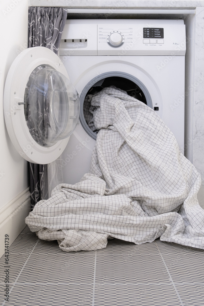 White sheet inside washing machine. Home appliances. White sheet inside washing machine. Home appliances.