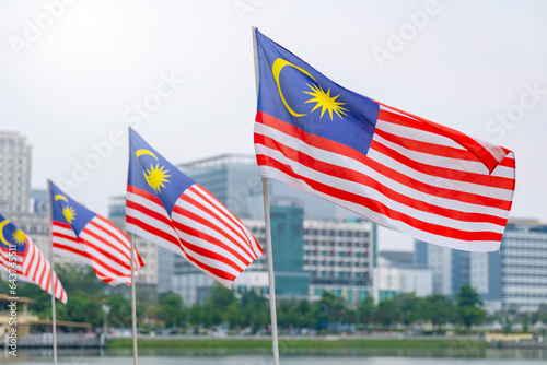 Photography The Malaysia flag is also known as Jalur Gemilang waving with a city in the background
