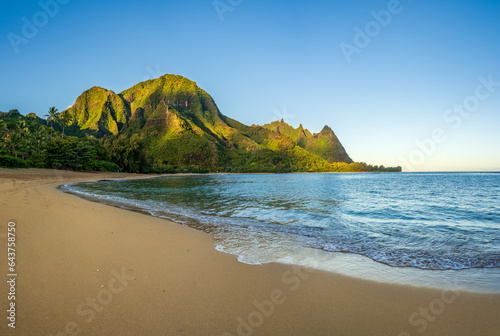 Aerial panoramic image of early morning light just catching the mountains. Tunnels beach on Hawaiian island of Kauai