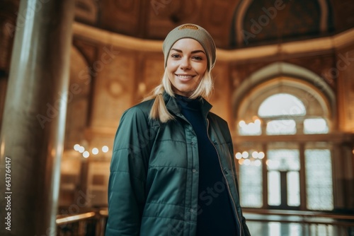 Lifestyle portrait photography of a merry girl in her 30s wearing a stylish varsity jacket at the blue mosque in istanbul turkey. With generative AI technology