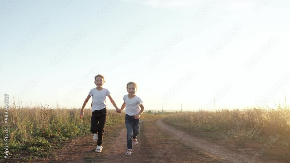 Active sisters run joining hands with dog in meadow in clear weather. Concept of fun on walk and love between family members slow motion Active sisters run joining hands with dog in meadow in clear weather. Concept of fun on walk and love between family members slow motion