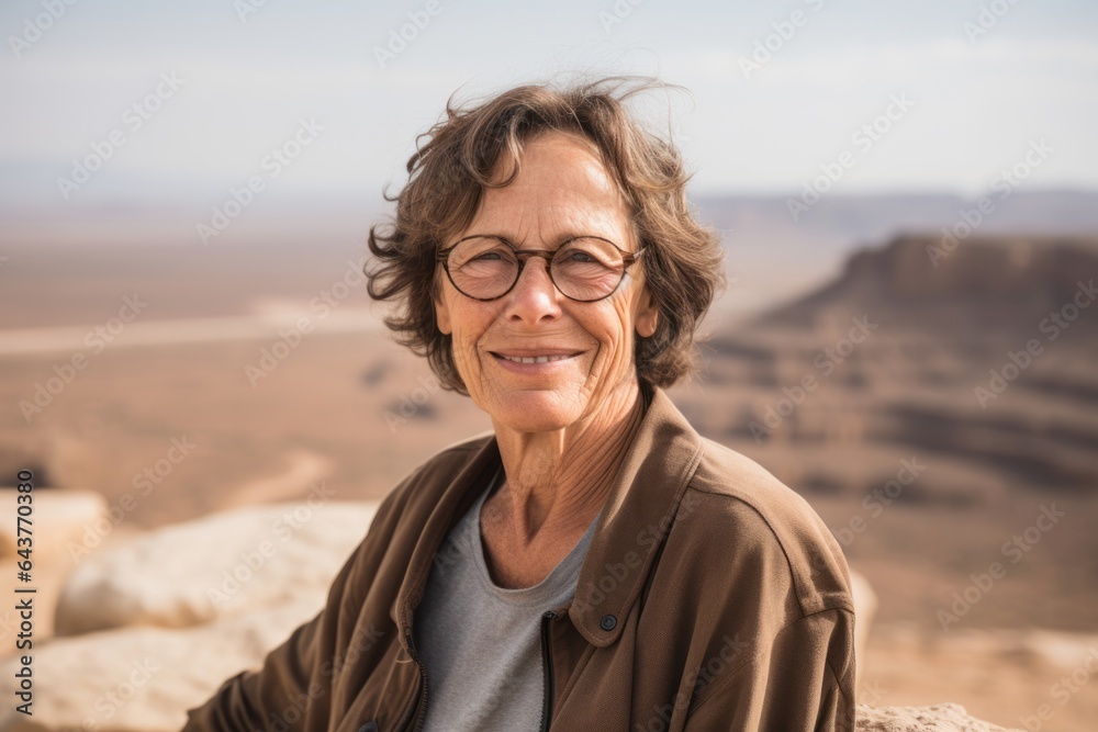 Lifestyle portrait photography of a glad mature woman wearing a trendy off-shoulder blouse at the masada in southern district israel. With generative AI technology