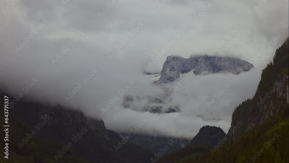 Dachstein in Summer: Snow-Capped Peak Amid Clouds Dachstein in Summer: Snow-Capped Peak Amid Clouds