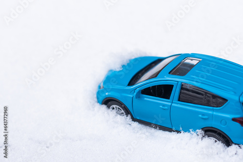 close up view of blue toy car with snow
