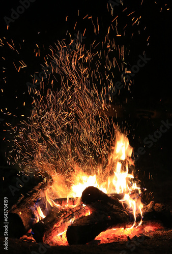 brigh sparkles over burning wood