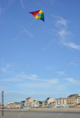 Tableau sur toile Bray Dunes, France, buildings at the seafront with colorful stunt kite in the sk