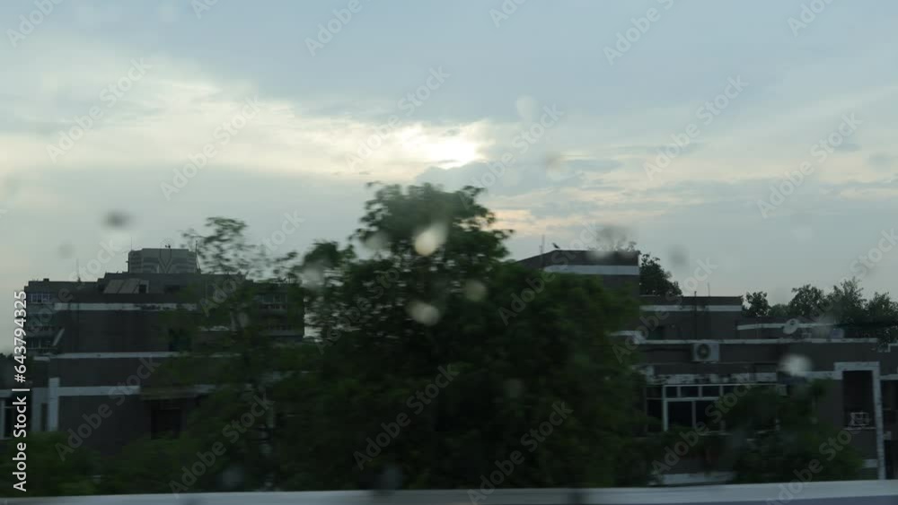Rainy day from a broken window pane. Shooting city life on rainy day from a cracked windshield. Beautiful view of hometown, green trees all around, wonderful sky. monsoon season. Rainy day from a broken window pane. Shooting city life on rainy day from a cracked windshield. Beautiful view of hometown, green trees all around, wonderful sky. monsoon season.