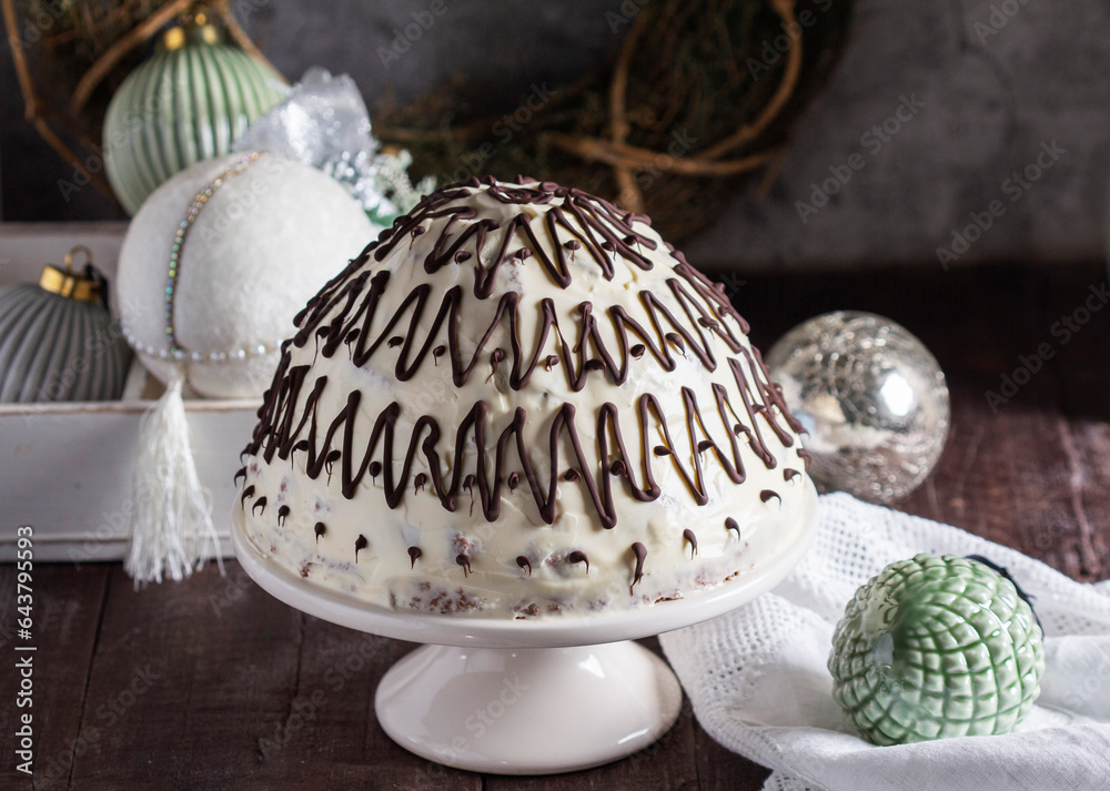 Pancho cake made of chocolate biscuit with sour cream and pineapple in New Year's or Christmas decoration. Rustic style.