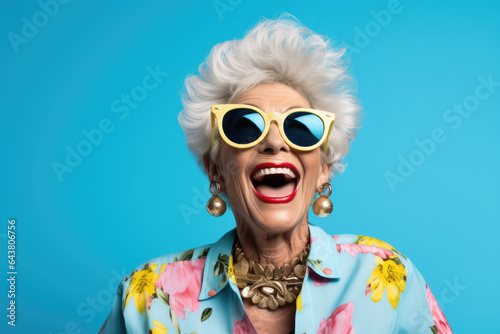 Woman wearing sunglasses and necklace is captured in moment of laughter. Joy, happiness, and carefree attitude. It is suitable for various marketing campaigns, lifestyle blogs, and social media posts. photo