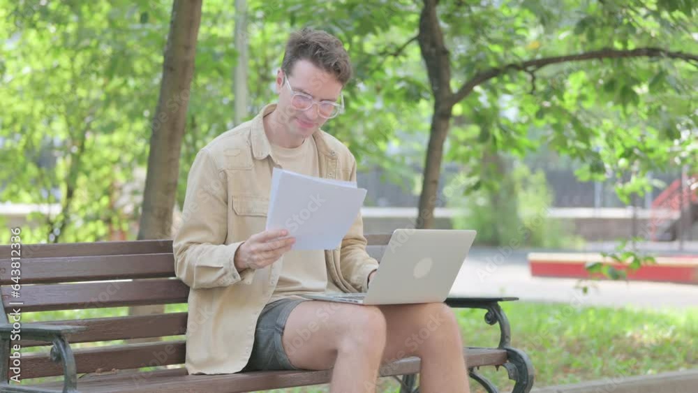 Modern Young Man Upset by Contract Failure and Using Laptop Outdoor Modern Young Man Upset by Contract Failure and Using Laptop Outdoor