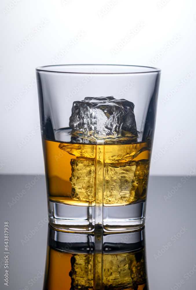 glass of whiskey with ice cubes glass of whiskey with ice cubes