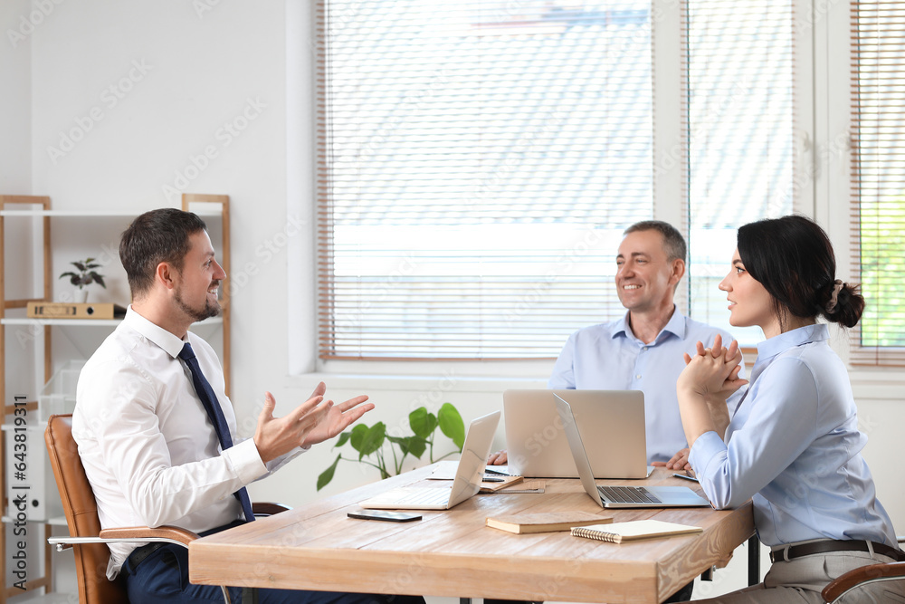 Business consultants working at table in office