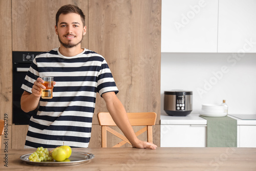 Young man with glass of jui...