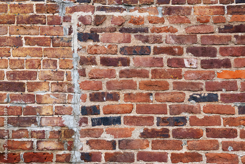 Konstfotografi Old red brick wall with patches in the background
