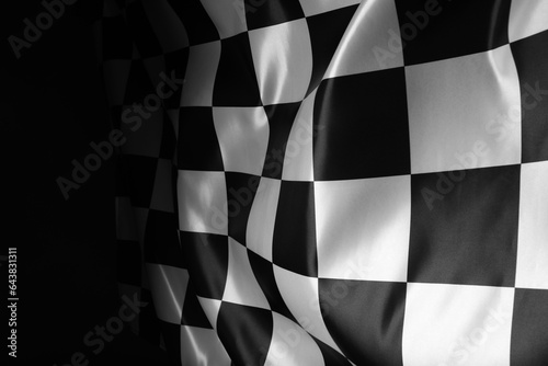 Checkered flag on black background, closeup view © New Africa