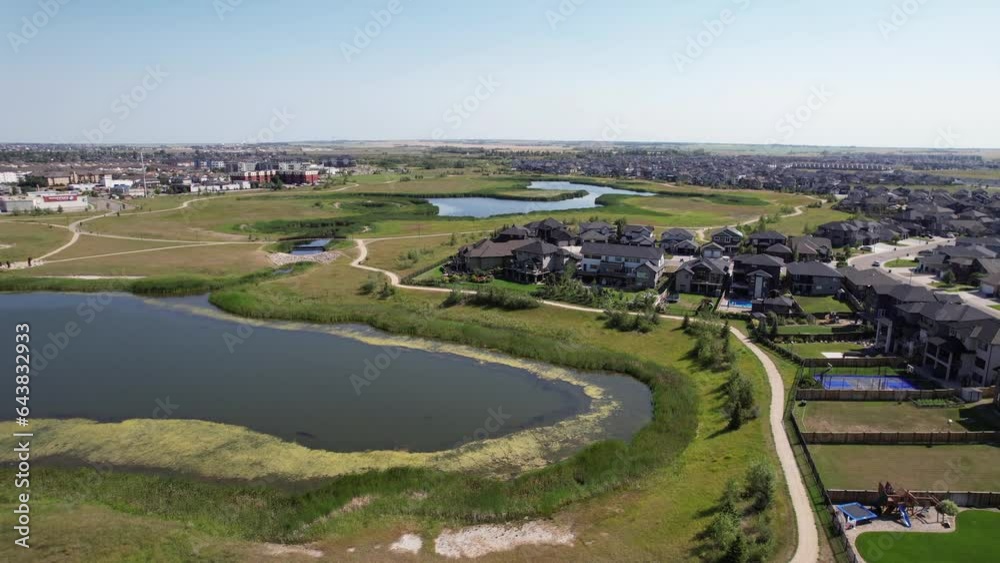 Aerial video of Rosewood, Saskatoon, SK, showcasing its modern subdivisions, green spaces, and interconnected streets. A rapidly-growing neighborhood epitomizing suburban innovation. Aerial video of Rosewood, Saskatoon, SK, showcasing its modern subdivisions, green spaces, and interconnected streets. A rapidly-growing neighborhood epitomizing suburban innovation.