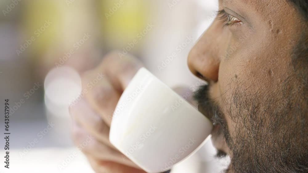 Close shot of male enjoying a cup of espresso, in slow motion