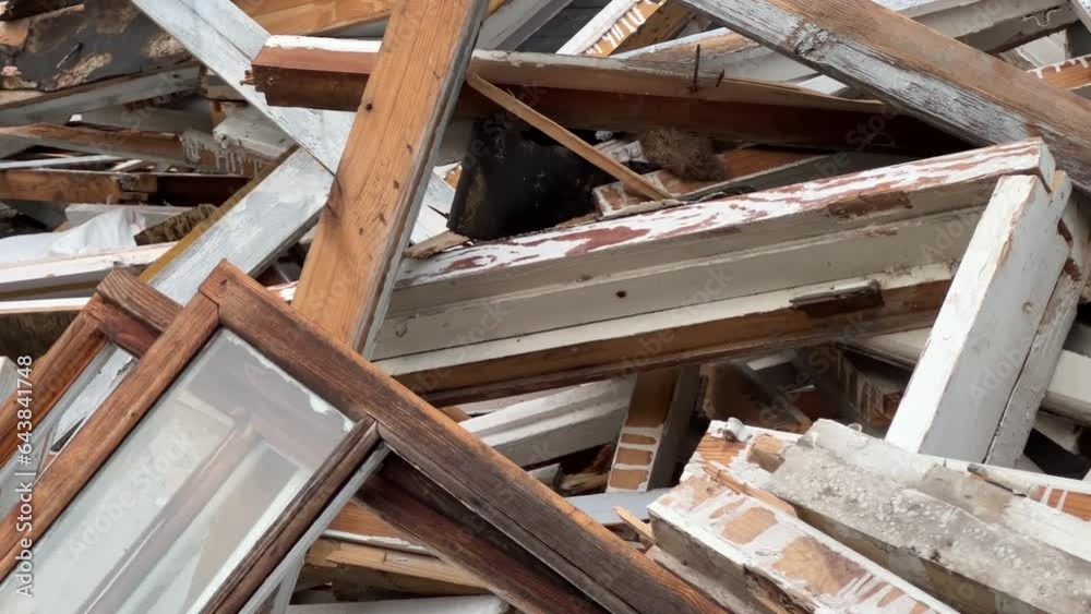 Old wooden windows lie in a pile near the building after being replaced with modern double-glazed windows. Long angle view Old wooden windows lie in a pile near the building after being replaced with modern double-glazed windows. Long angle view