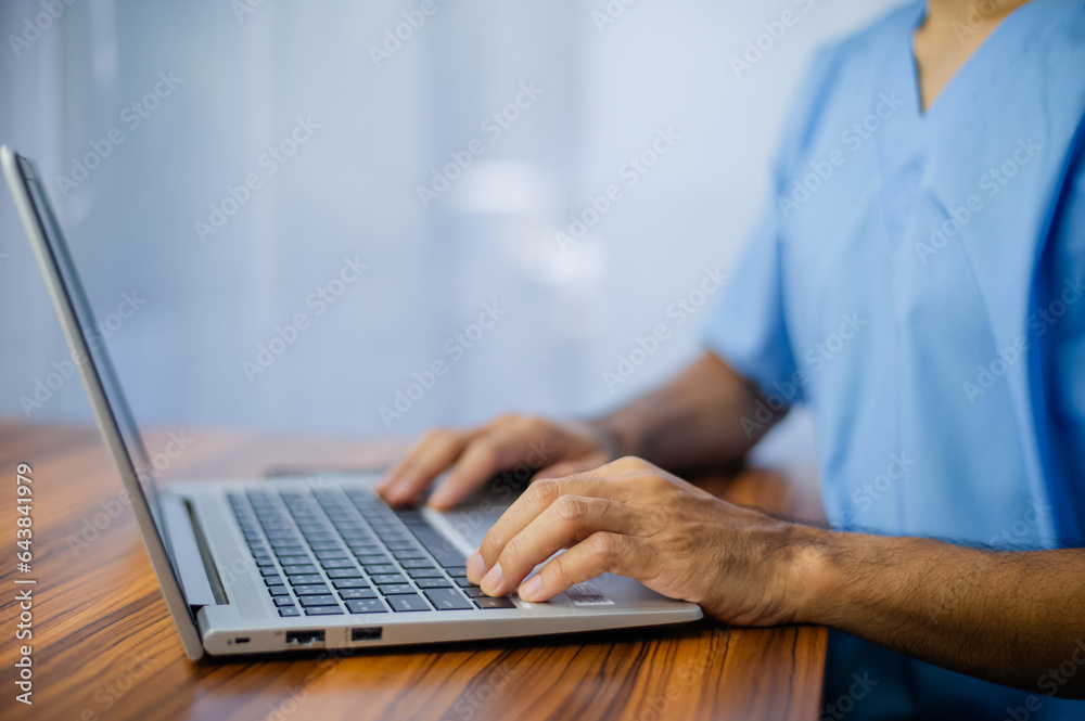 Doctor using laptop computer on desk office Doctor using laptop computer on desk office
