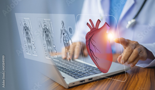 Photography cardiologist doctor using computer visual screen learning data for treatment