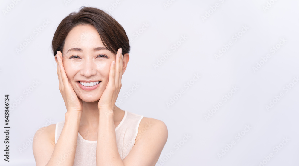 Skin care. Woman with beauty face touching healthy facial skin portrait. Asian woman.
Skin care. Woman with beauty face touching healthy facial skin portrait. Asian woman.