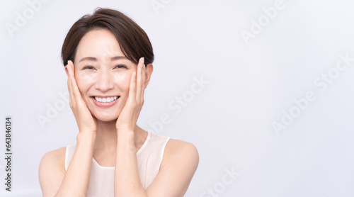 Skin care. Woman with beauty face touching healthy facial skin portrait. Asian woman.	
