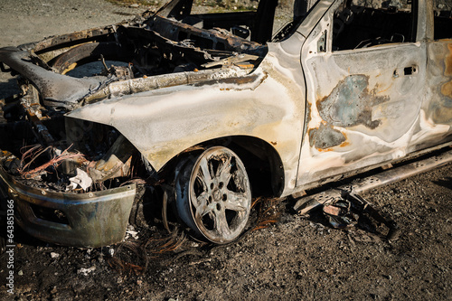 A burned out Dodge pick up truck lies abandoned beside a gravel road in rural British Columbia  Canada.