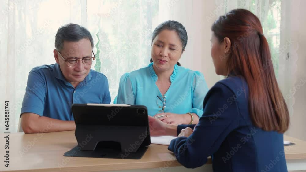 Young asian woman counseling to elderly couple husband and wife about insurance life for planning in living room at home, insurance life agent or consultant explaining with senior for decisions. Young asian woman counseling to elderly couple husband and wife about insurance life for planning in living room at home, insurance life agent or consultant explaining with senior for decisions.