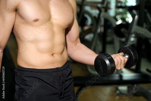 Closeup and crop perfect body with weight training at fitness center.