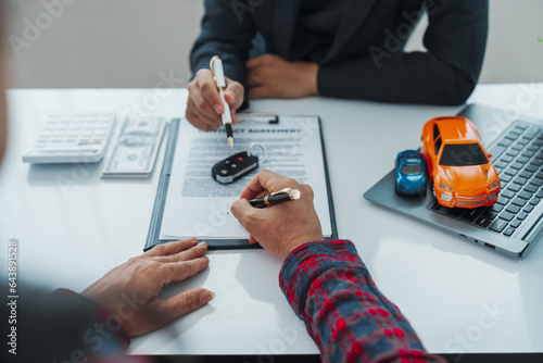 Businessman completes successful car purchase transaction by gifting car keys after finalizing contract signing, great investment, handover of keys, satisfaction purchase new or used vehicle