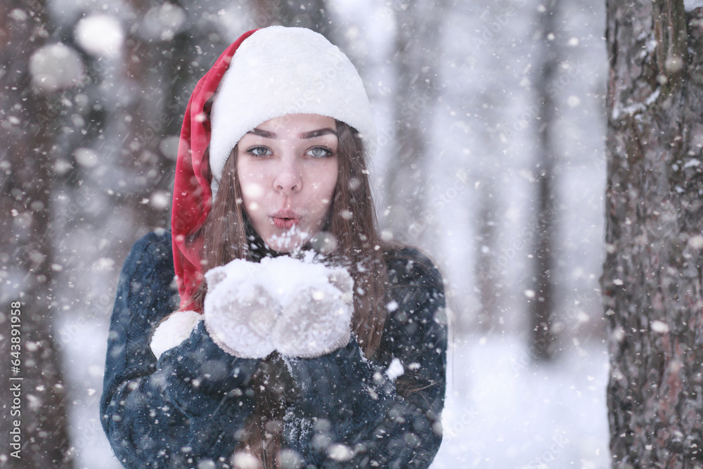 Girl in a winter park in snowfall