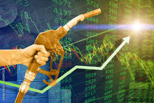Fotografia crude oil retail price increase rise high concept, green business stock chart overlay hand with fuel nozzle up arrow