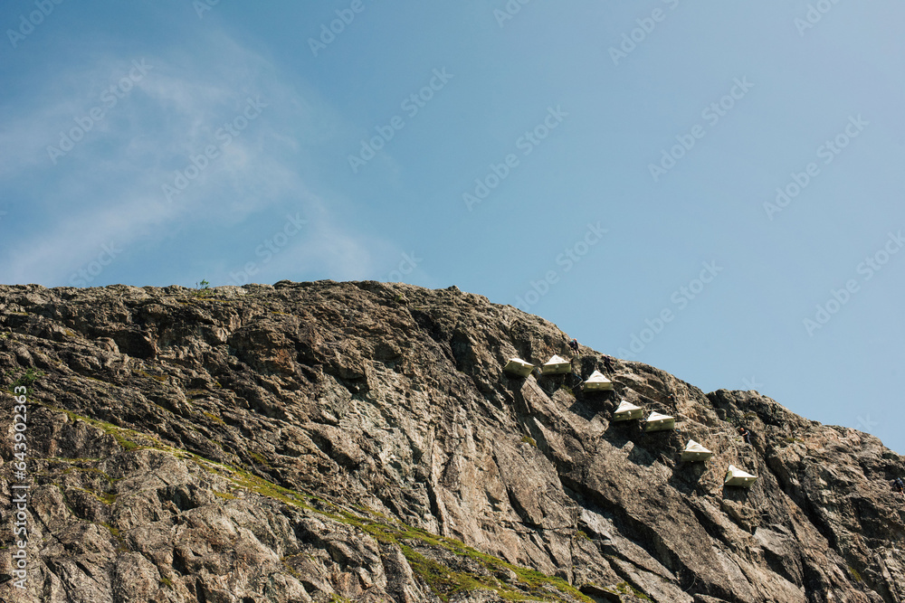 Portaledge tents hanging from a cliff in Norway