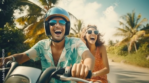 Happy young couple riding a moped in a tropical country