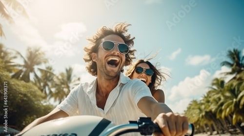 Happy young couple riding a moped in a tropical country © olegganko