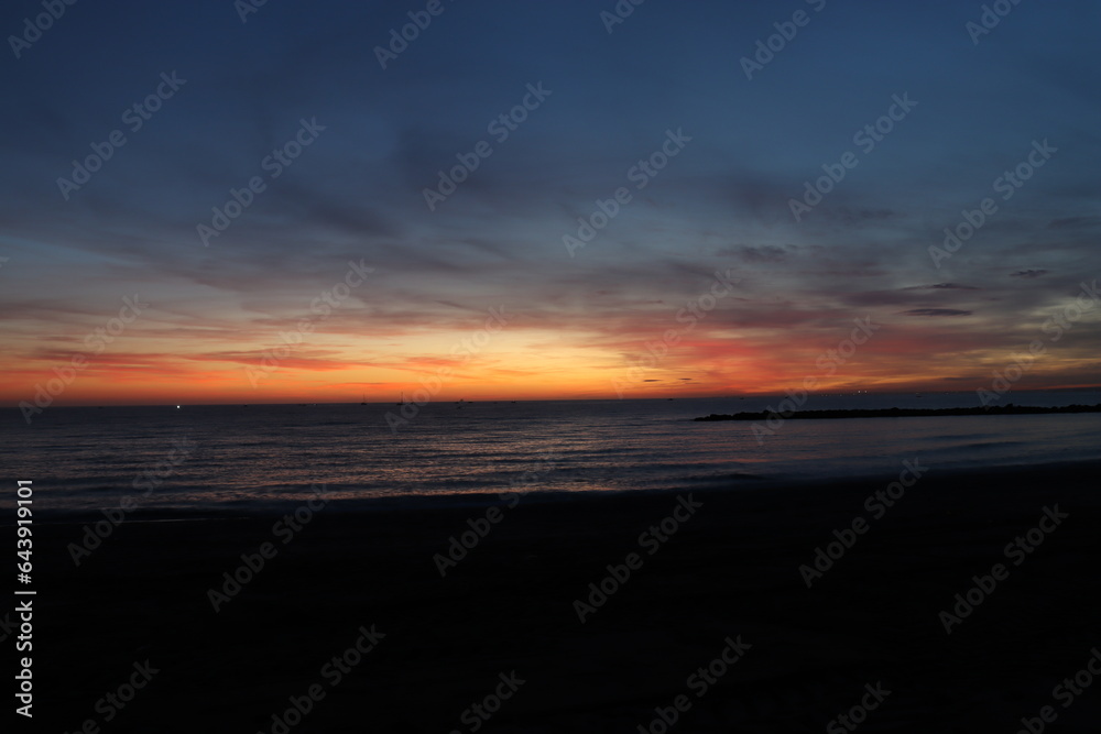 Sunset on the Zapillo beach in Almeria, Spain, sun hidden behind the horizon
