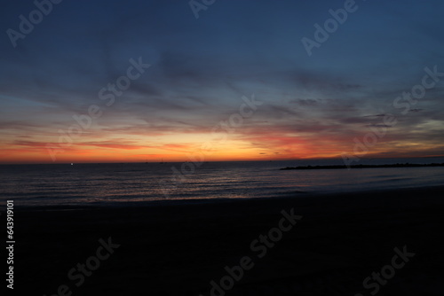 Sunset on the Zapillo beach in Almeria, Spain, sun hidden behind the horizon