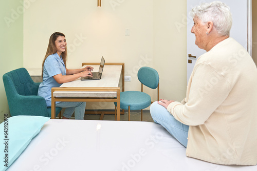 Doctor talking with an old woman in the clinic