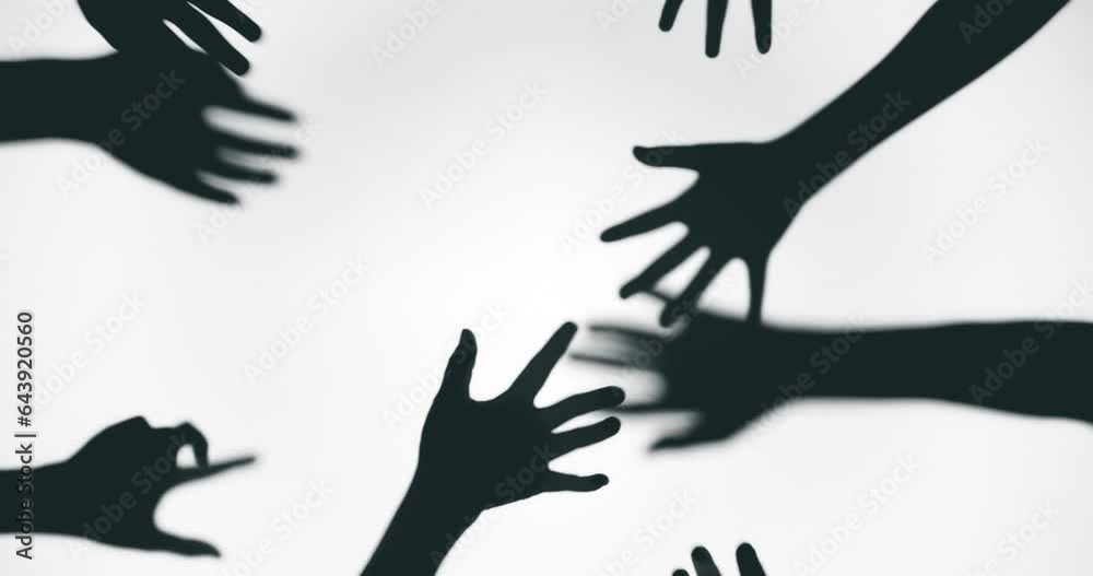 Shadow of a zombie hand on white background in slow motion
Shadow of a zombie hand on white background in slow motion