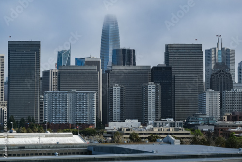 Sunny day with low hanging clouds day in San Francisco Bay with port piers, city skyline downtown architecture highrise buildings and landmarks as Coit Tower, Pyramid and Alcatraz © Tamme