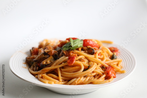 plate of seafood spaghetti with tomato