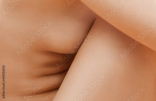 Part of a naked female body close-up. Body-positivity, self-love, acceptance. Concept of femininity and body care