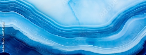 Closeup of polished abstract blue white agate crystal natural quartz healing stone texture background