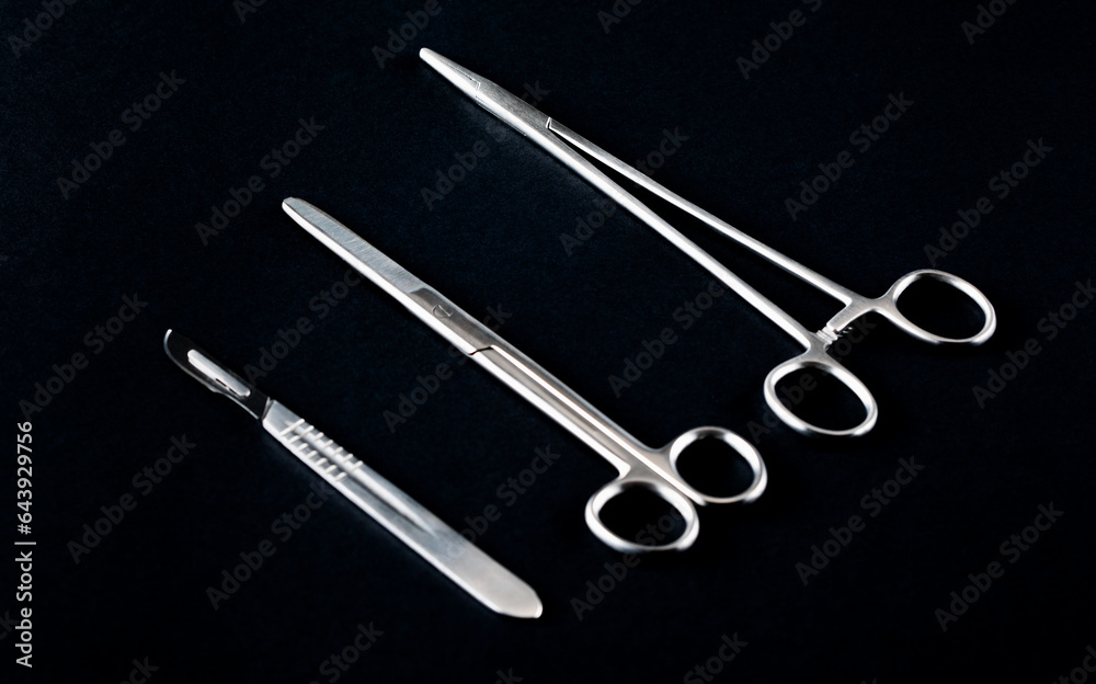 Sterile instruments on a black background close-up. Preparing instruments for surgery. Sterile instruments on a black background close-up. Preparing instruments for surgery.